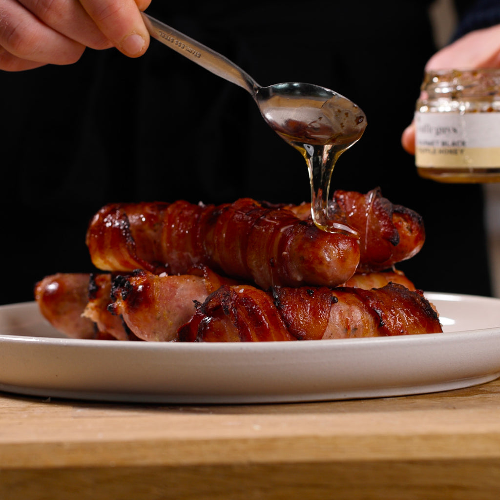 Jumbo pigs in blankets with truffle honey